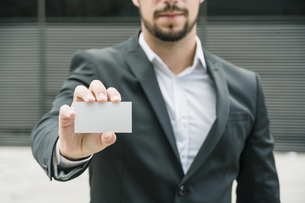 close-up-businessman-standing-outdoors-showing-blank-white-business-card_23-2148026638.jpg